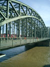 Hohenzollern Bridge behind the dome with trains and people